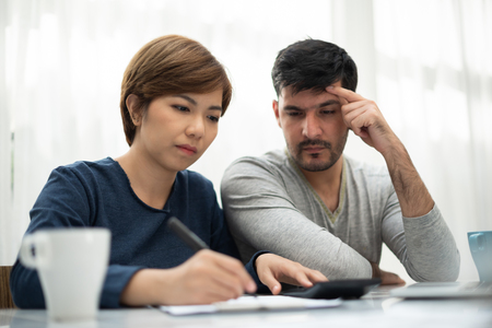 Stressed Young couple calculating their budget for new house.の写真素材