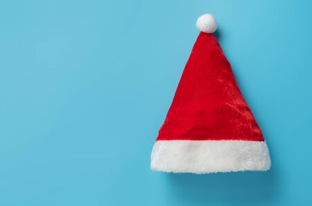 Top view of Santa claus hat on blue background. Merry Christmas and Happy New year concept. Copy space.の写真素材