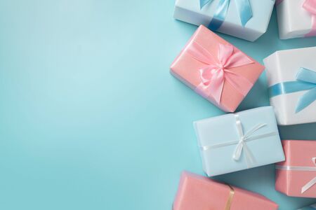 Top view of colorful gift boxes on blue isolated background with copy space. Christmas, Birthday and...