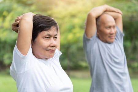 Asian senior people stretching their arms before exercising. Copy space. Good health.