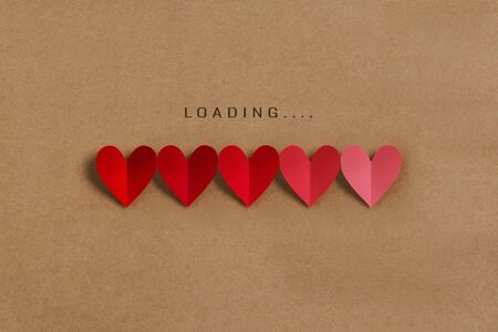 Loading progress bar with red and pink hearts on brown paper background. Valentine's day, Love, Life...
