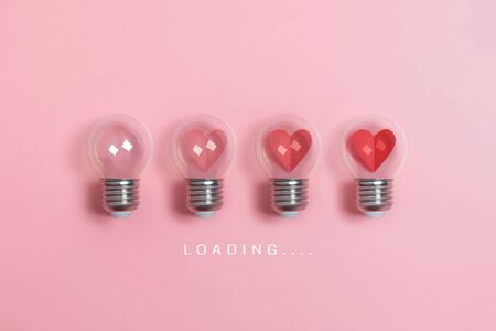 Red hearts in light bulbs. Loading progress bar on pink background. Valentine's day, Creative idea, Love, Inspiration Concepts.の写真素材