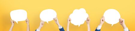Diverse Group of Business People are holding white Speech Bubbles on isolated yellow background....