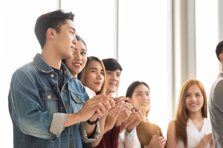 Group of Creative designers audience applauding at seminar. Young Asian Business People in casual listening and clapping hands at conference and presentation.の写真素材