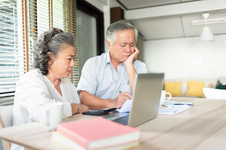 Asian Senior Couple having debt and financial problems, feeling stressedの写真素材