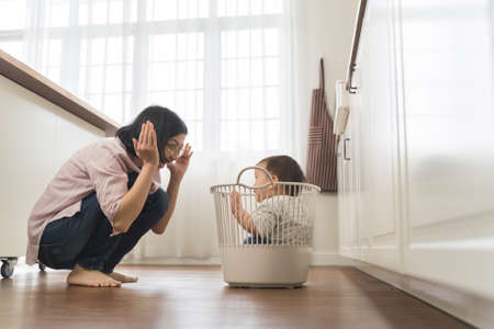 Asian Young Mother playing with her little son at homeの写真素材