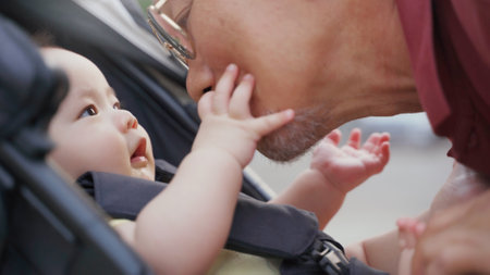 Asian little Adorable Baby boy in baby stroller playing with his Grandfather while walking in the park at outdoor together. Loving Different Family generations.の写真素材