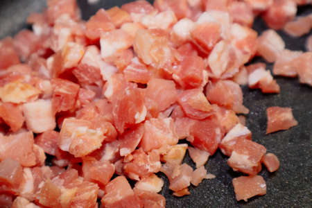 cutted bacon cubes in a panの写真素材