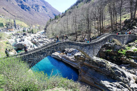 Lavertezzo, Switzerland, 10. April 2022: Historic Romain Bridge, Ponte dei Salti, leading over the...