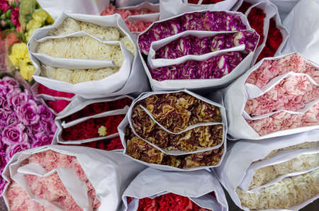 Different coloured roses in paper packaging thai style - close up