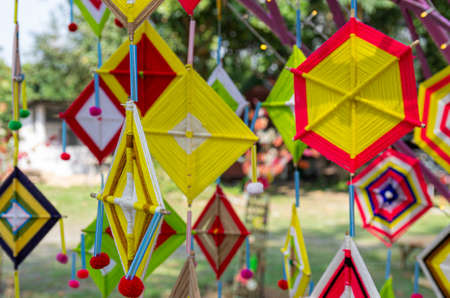 Picture of colorful hanging graphic elements made of yarn for Loi Krathong festival - selected focusの写真素材