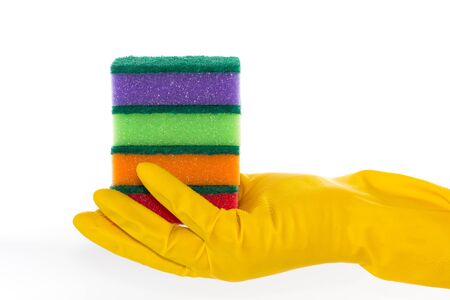 Hand in rubber glove holds several cleaning sponges on isolated backgroundの写真素材