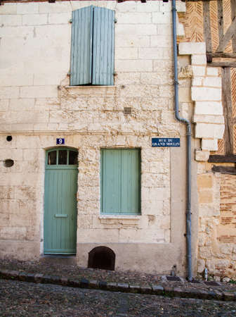 Front door and closed shutters in Bergerac, France