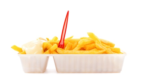 Portion of French fries with mayonnaise and plastic fork in disposable tray