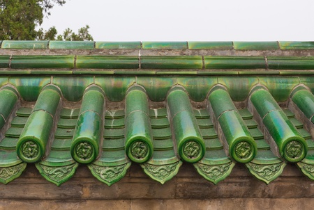 Green glazed roof tiles on wall in Chinaの写真素材