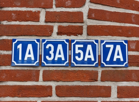 Multiple house numbers on wallの写真素材