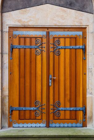 Portal with wooden doors and decorative fittingsの写真素材