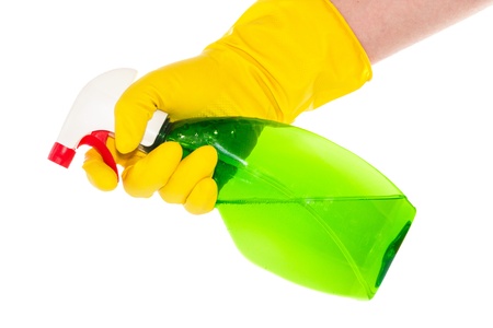 Hand with yellow household gloves holding a green spray bottleの写真素材