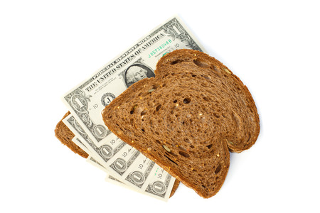 Two slices of bread topped with cash one US dollar billsの写真素材