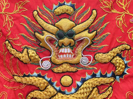 Tapestry of a Golden Dragon on a Red Silk Backgroundの写真素材