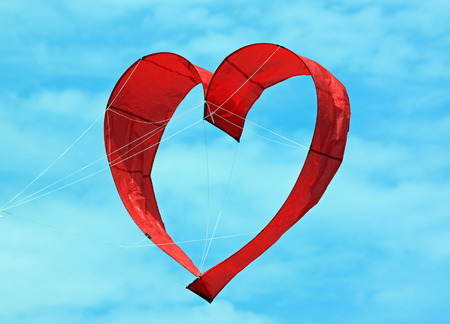 Red Heart Kite in a Blue Skyの写真素材
