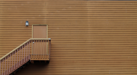 Wooden Stairs Leading to a Door in the middle of a Wallの写真素材