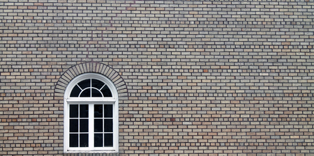 Single Decorative Window in a Tan Brick Buildingの写真素材