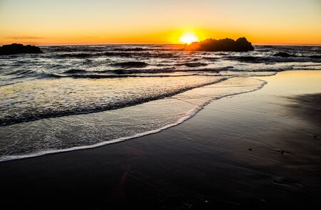 Sun Setting Behind a Seastack in Lincoln City on the Oregon Coastの写真素材