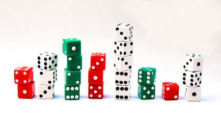 Several Stacks of Red, Green, and White Dice Cubes on a white background