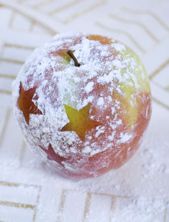 Christmas apple with icing sugar decorationの写真素材