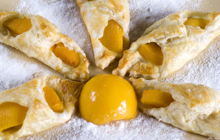 A sweet puff pastry peach on a plate の写真素材