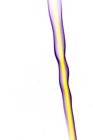 purple smoke with a yellow stripe on white の写真素材