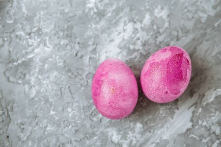 Colorful decorated easter eggs on gray plaster background. Happy Easterの写真素材