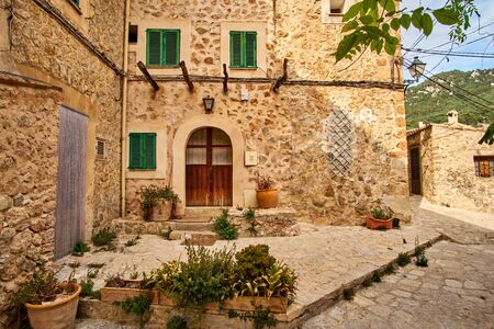 Old European street decorated with fresh flowers city of Valldemossa. Palma de Mallorca. Spain.