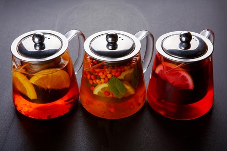 Fruit tea with slice of lemon. Mixture herbal floral fruit tea with petals, dry berries and fruits.の写真素材