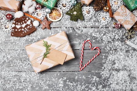 Gift boxes, Christmas decorations and pine cones on gray wooden table. Christmas background. Space for text. Top view.の写真素材