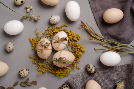 Eggs with flowers and decorative elements on concrete