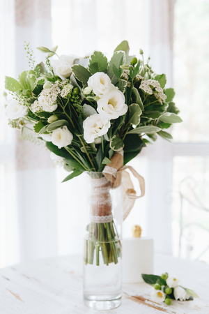 Table decor with white flowers and candles for a wedding partyの写真素材
