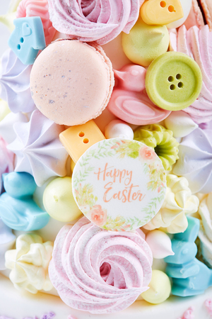 Easter dessert for children: colorful candy treats with cookies and meringue. Happy Easter