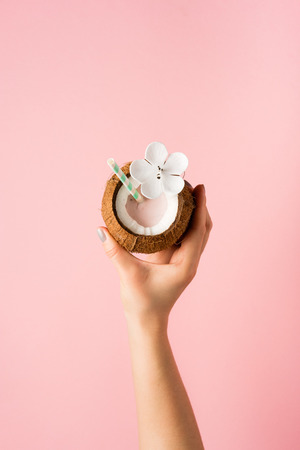 Refreshing summer drinks. Coconut drink on pastel pink background. Trendy summer colorの写真素材