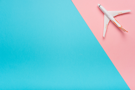 Top view of an airplane on trendy color background.  Bright summer color. Travel conceptの写真素材