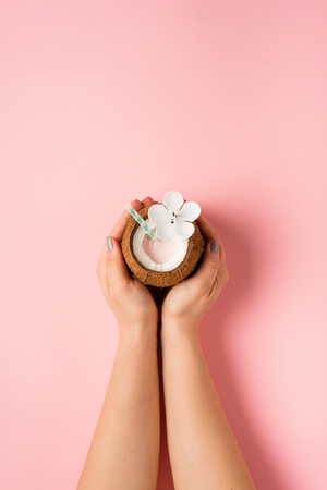 Refreshing summer drinks. Coconut drink on pastel pink background. Trendy summer colorの写真素材