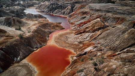 Fantastic earth with red river at aerial view. Fantastic view. Martian landscape