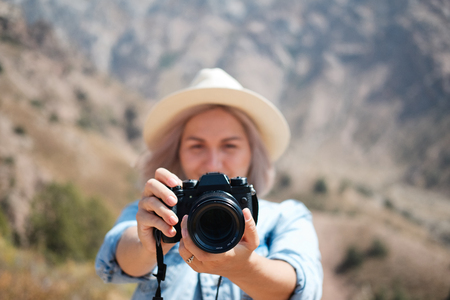 Hiker photographer taking picture of the landscape with mountains.の写真素材