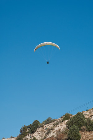 Paraglider is flying in the blue sky. Paragliding in the sky on a sunny dayの写真素材