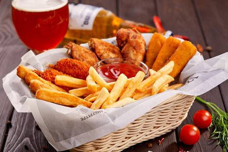 Fried chicken wings breaded crispy with potato fries. Beer snack.の写真素材
