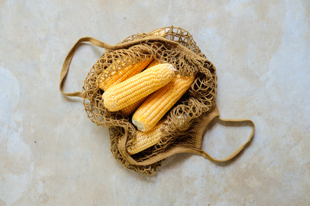 Fresh Sweet Corn Cob in Eco Textile Net Bagの写真素材