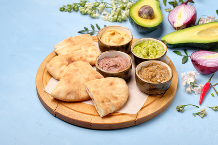 Arab Traditional Pita Bread with Tasty Guacamole. Spice, Flower and Avocado with Onion on Rustic...