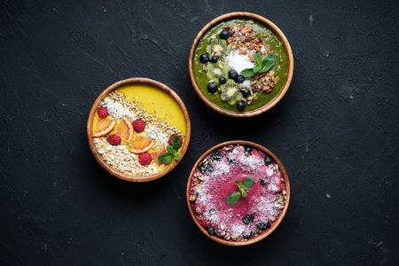 Smoothie bowls. Healthy breakfast bowl with chia seeds, muesli, berries, fruits and coconut flakes coconut flakes. Vegan foodの写真素材