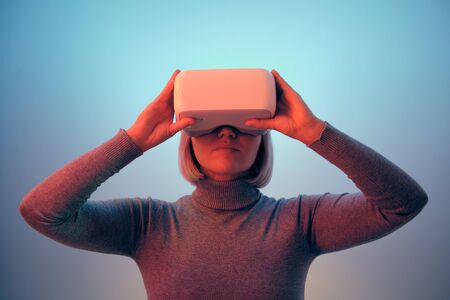 Young Woman Playing on Vr Glasses Touching Airの写真素材